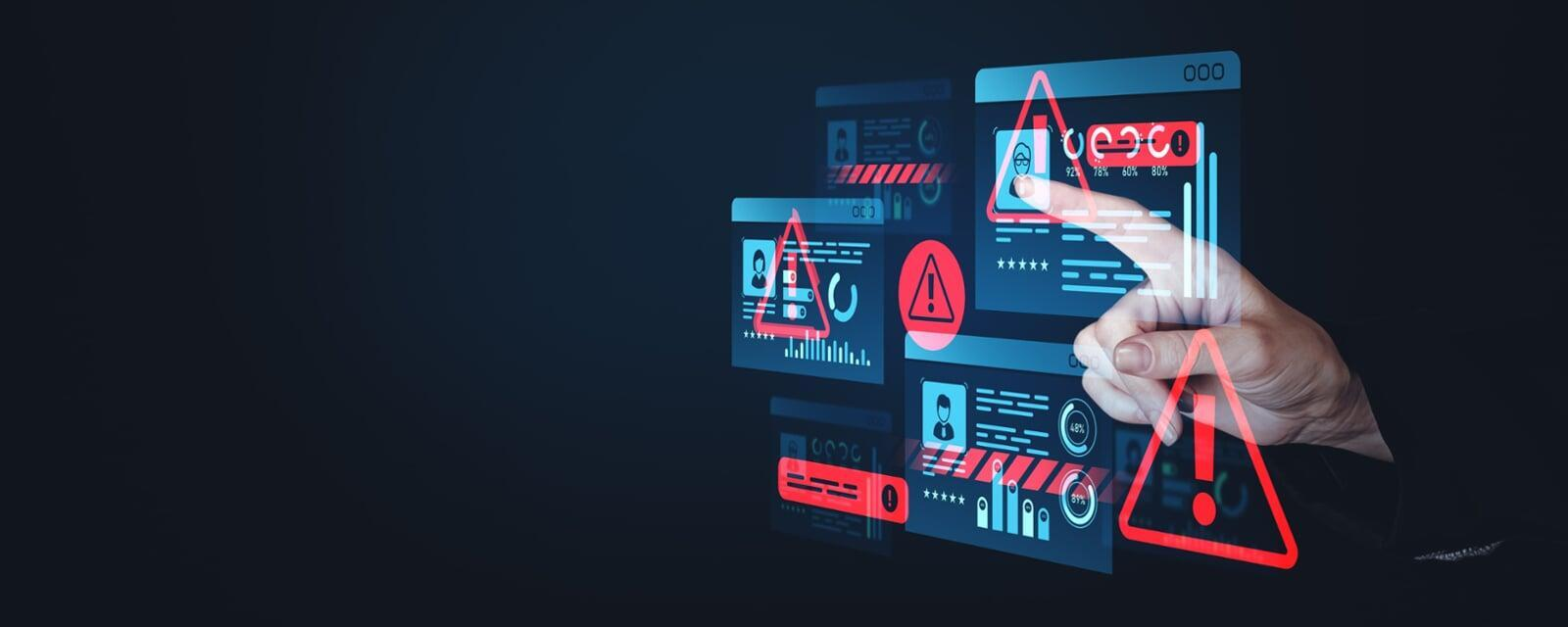 Hand interacting with holographic digital screens displaying red security warnings, symbolizing active cyber attack prevention