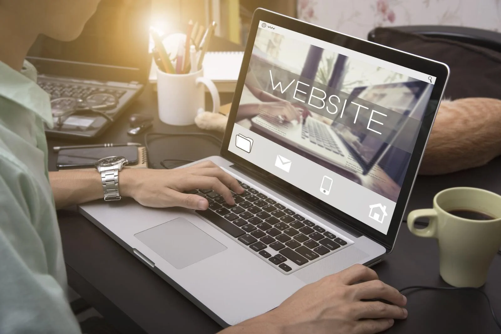 Top-down view of a tidy white desk with a laptop and coffee, symbolizing a secure environment for data sharing and privacy.