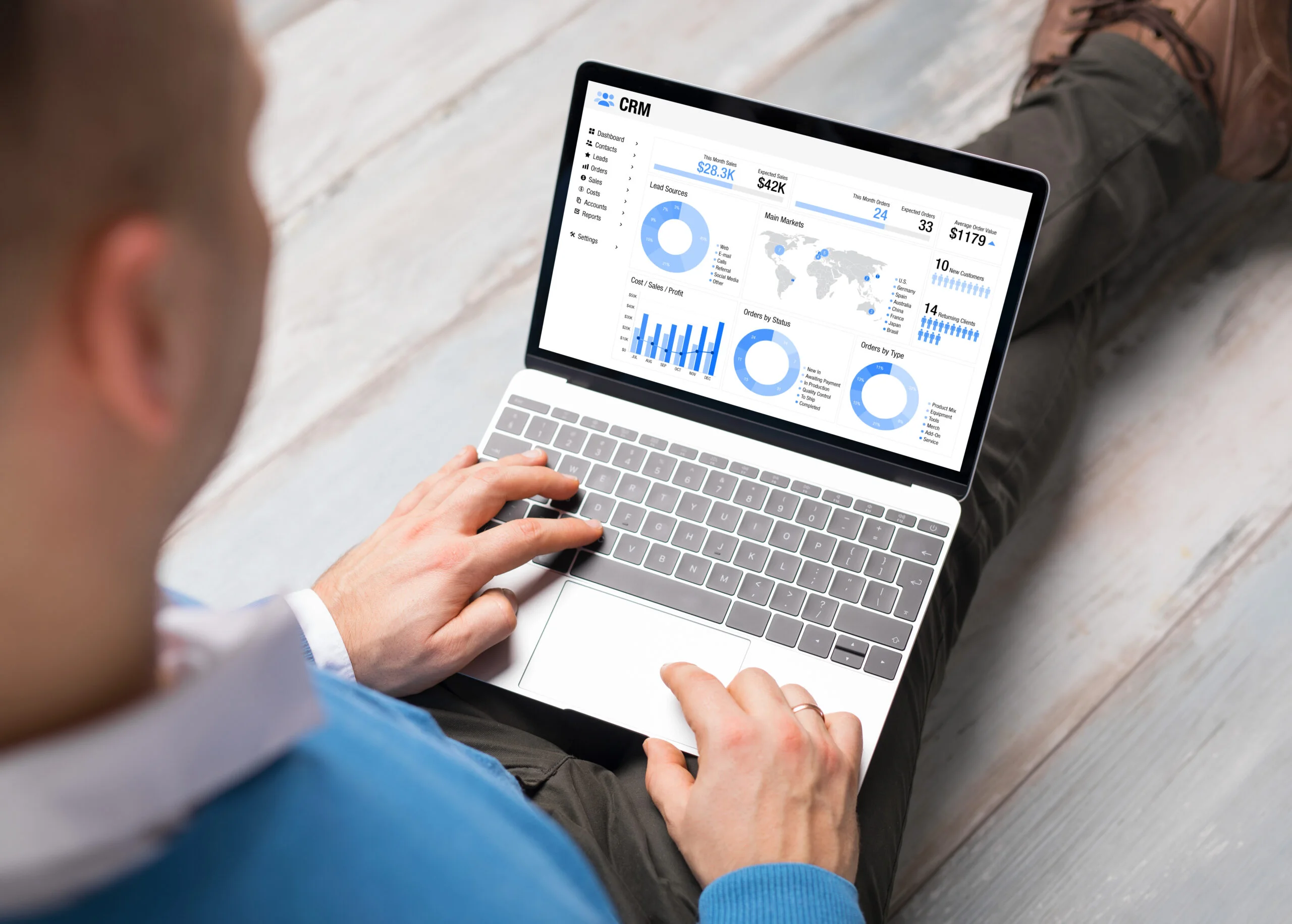 A person viewing a CRM dashboard on a laptop, highlighting the types of customer data managed by a data retention policy for small businesses.