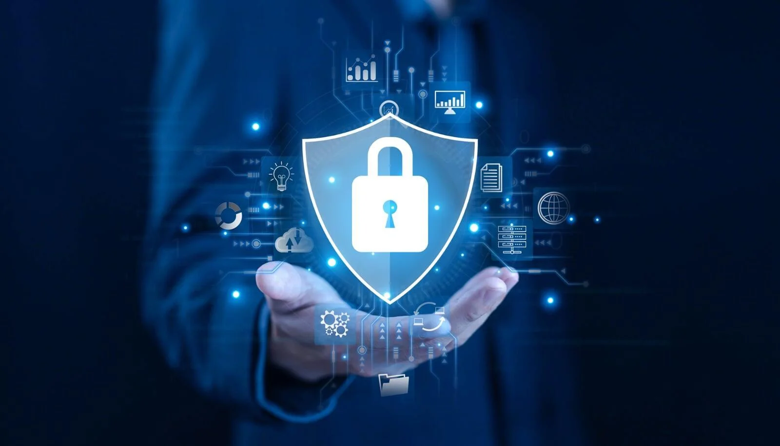 Hand holding a glowing digital shield and lock, surrounded by connected icons, symbolizing comprehensive IoT cybersecurity solutions.