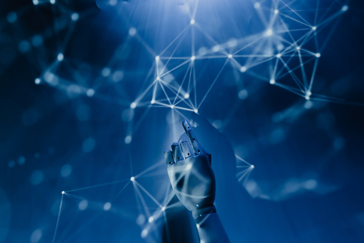 Robotic metallic hand pointing up towards a glowing white network on a deep blue background, symbolizing AI software for small business connectivity.