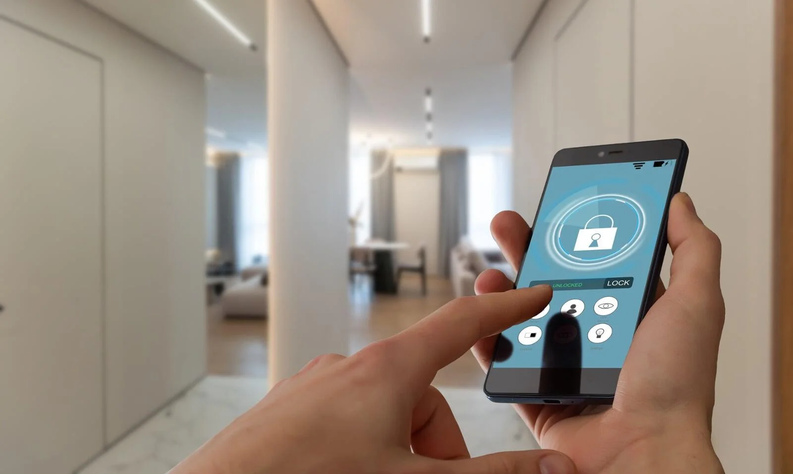 Hands using a smartphone with a security lock screen, demonstrating remote control for smart home tips.