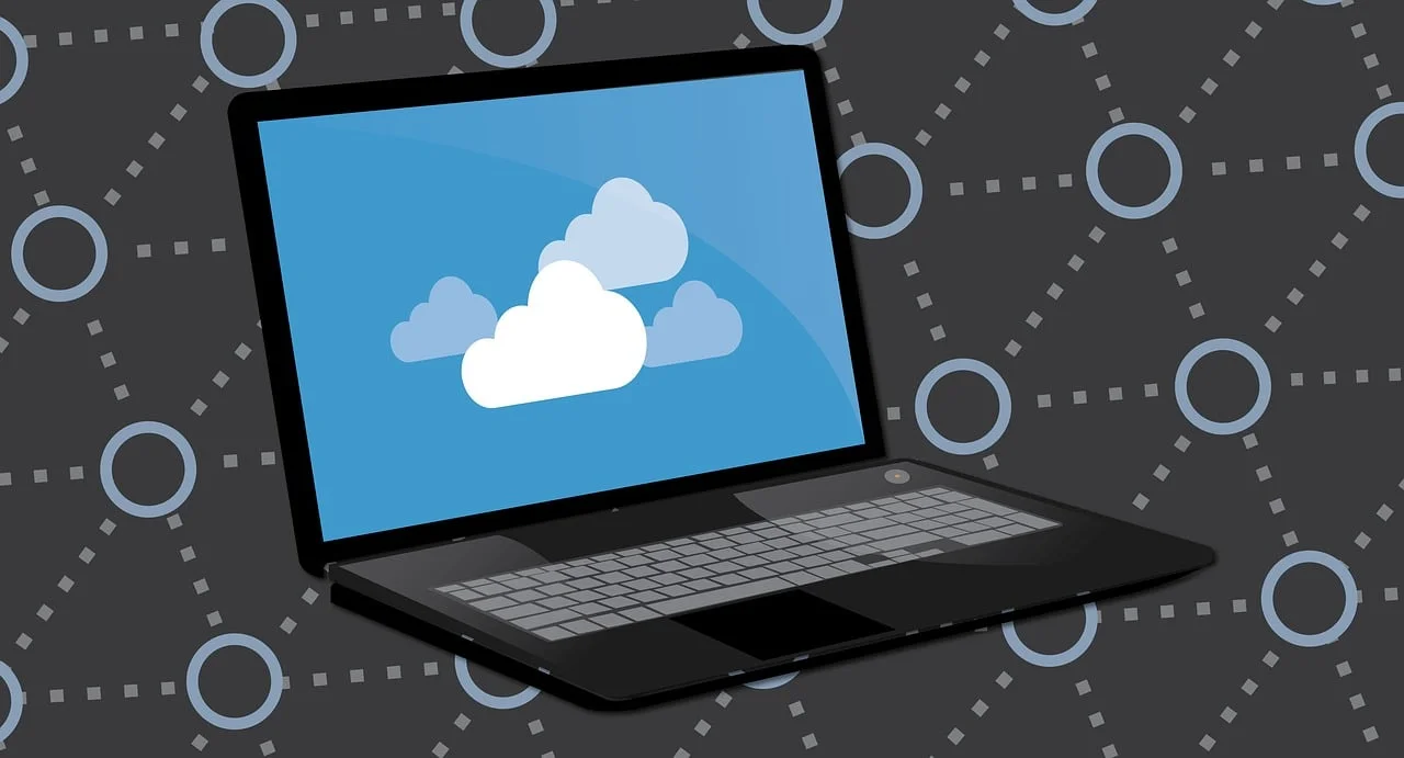A laptop displaying cloud icons against a dark networked background, symbolizing the digital footprint left by hidden services that IT teams must identify to uncover unsanctioned cloud apps.