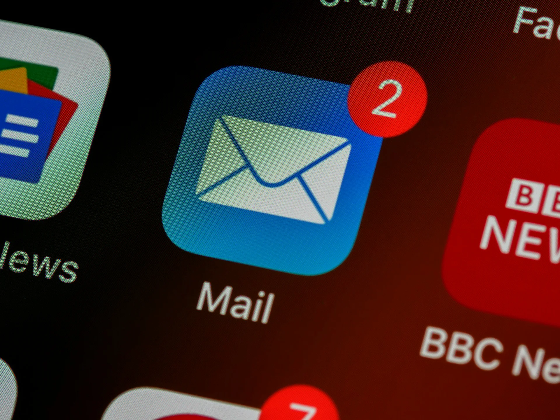 A smartphone screen showing a blue mail app icon with unread notification badges, illustrating inbox security and How to Stop Email Spoofing.