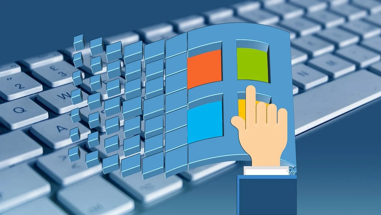 Windows logo breaking apart above a computer keyboard, symbolizing system disruptions and a Microsoft 365 outage.