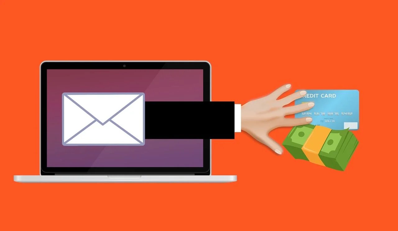 An illustration of a hand reaching out from a laptop email envelope to grab cash and a credit card, illustrating online fraud and How to Spot a Phishing Email.